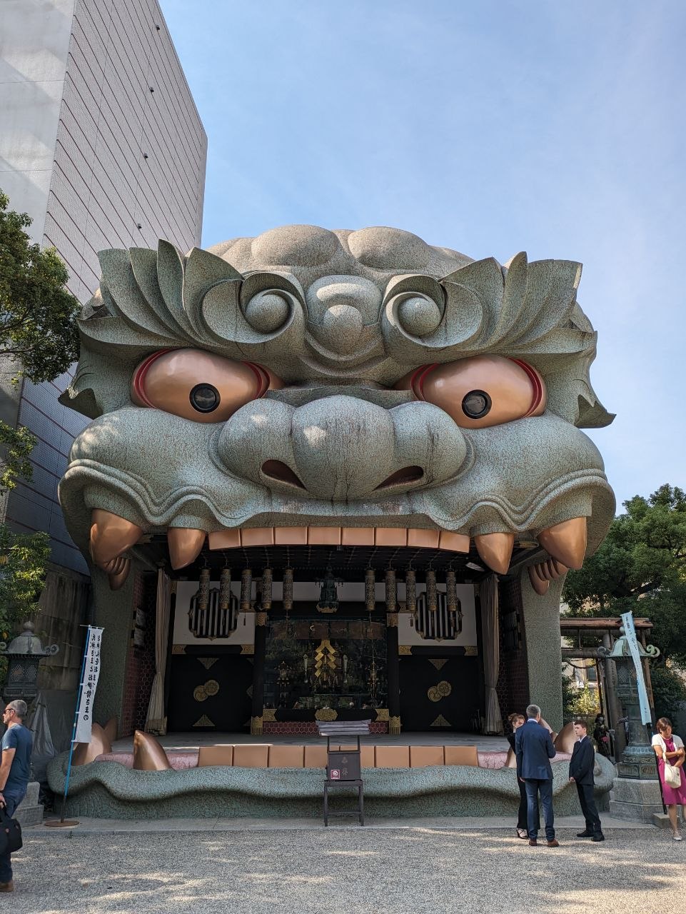 Details of Namba Yasaka Shrine with visitors exploring the grounds