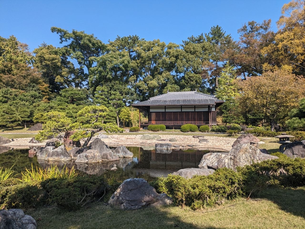 Traditional pavilion reflected in the pond of Ninomaru Garden at Nijo Castle