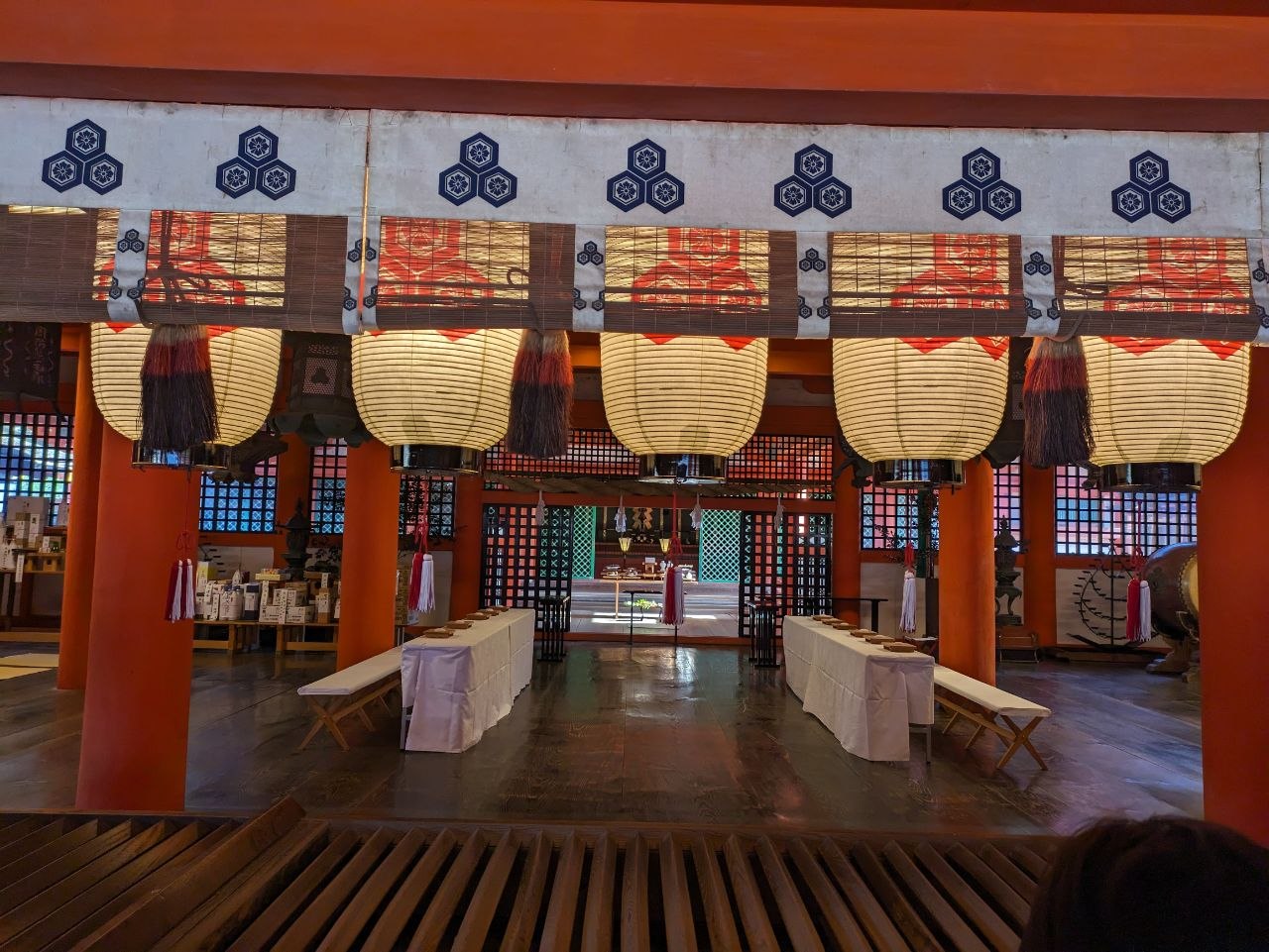 Interior of Itsukushima Shrine with paper lanterns and red pillars