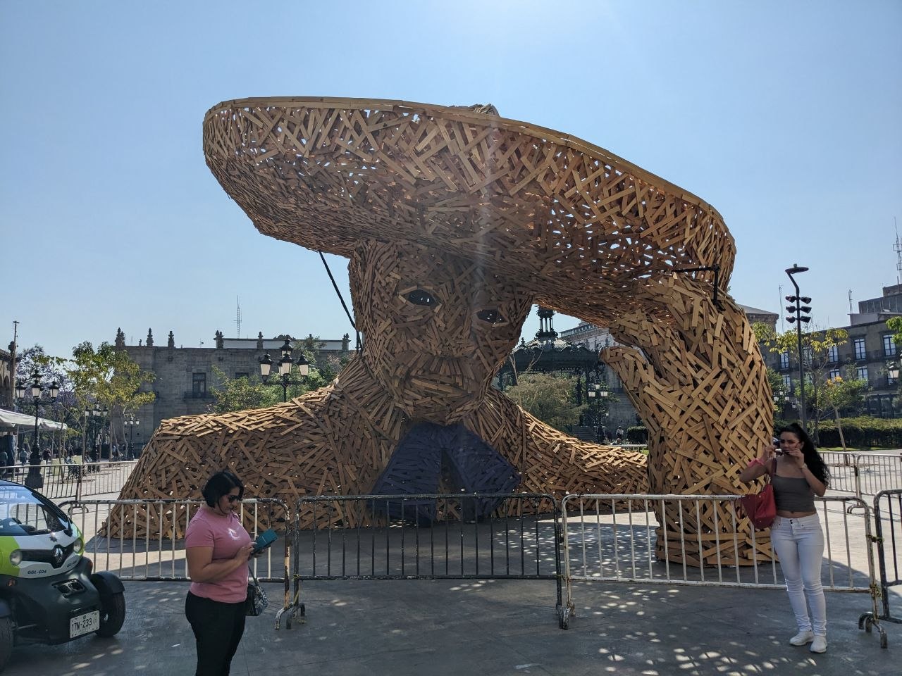 Large-scale woven wood sculpture of a figure in a sombrero installed in the historic center of Guadalajara