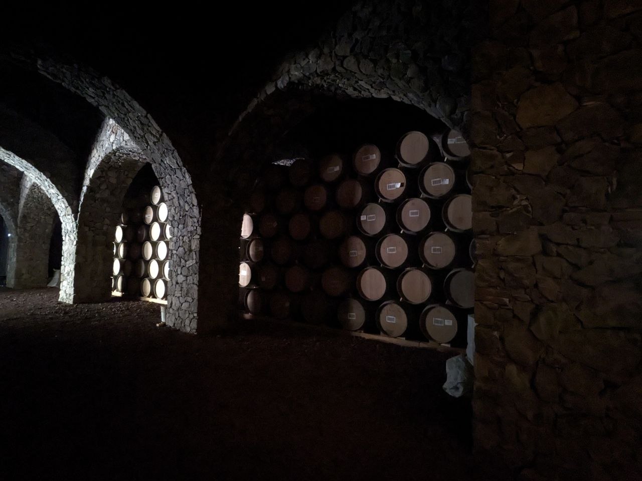 Oak barrels aging tequila in a distillery warehouse in Tequila, Jalisco