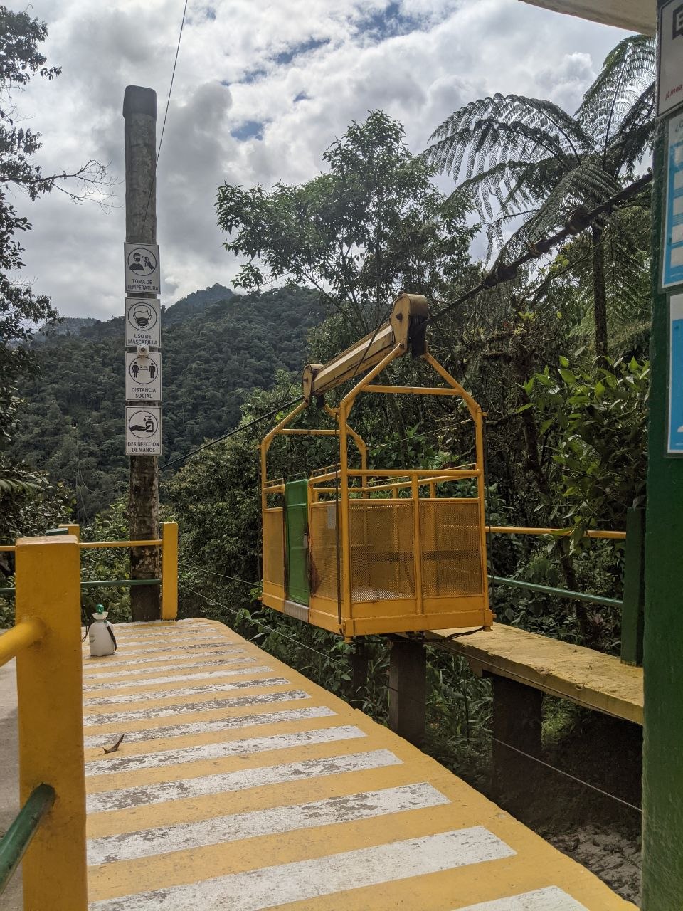Yellow cable car tarabita gondola at the jungle entrance of Santuario de las Cascadas, Mindo Ecuador