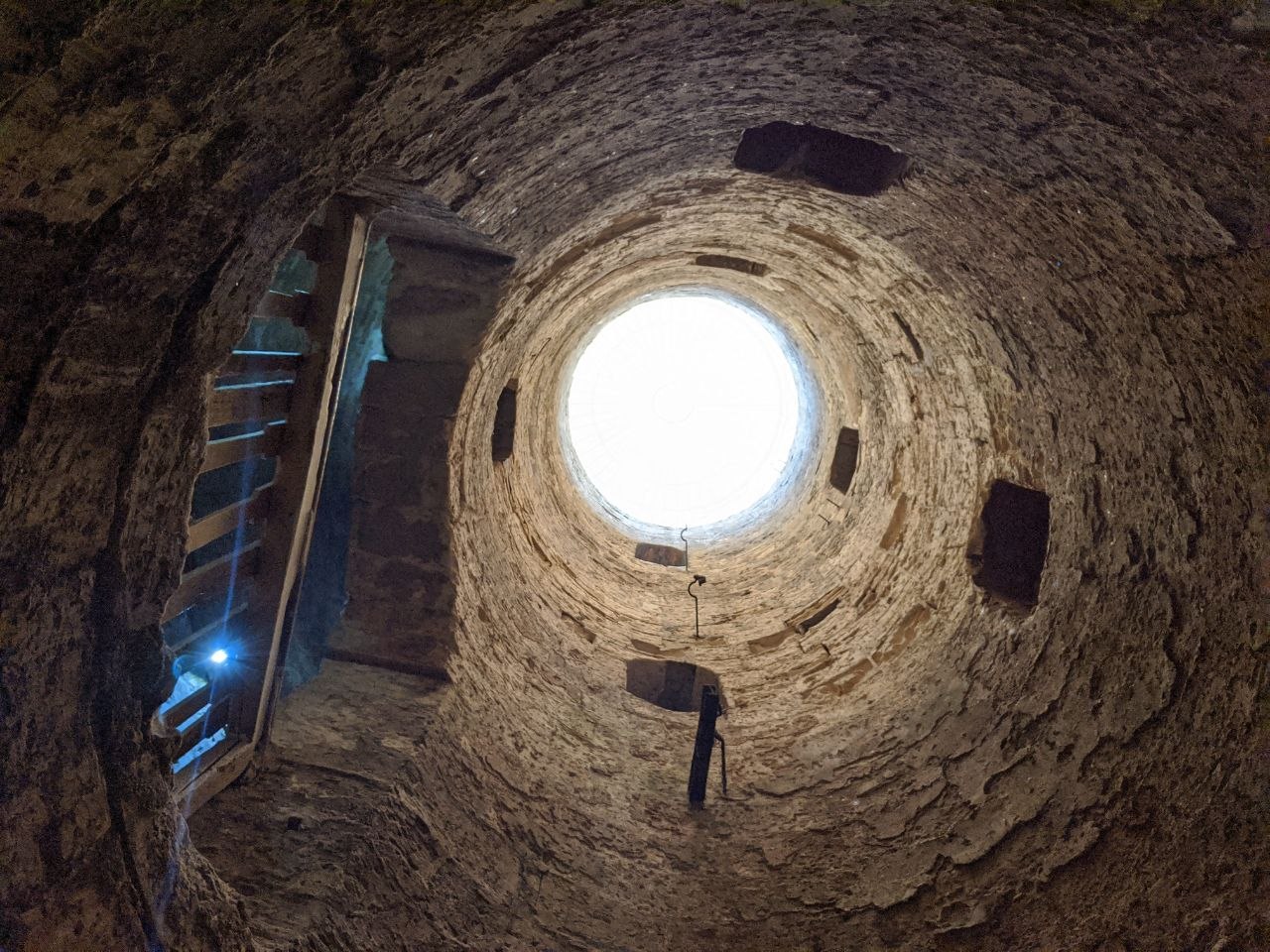 Looking up through a circular shaft in the underground cisterns beneath the Serapeum site, Alexandria