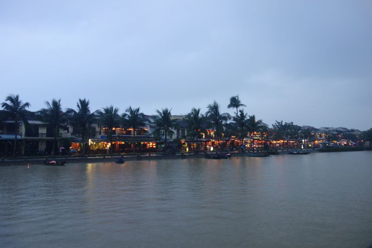Hoi An ancient town waterfront at dusk with silk lanterns reflected in the Thu Bồn River