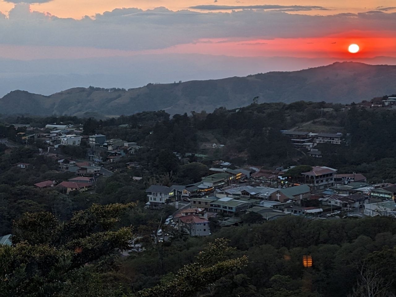 Aerial view of Santa Elena town at sunset with the Pacific Ocean visible on the horizon, Monteverde, Costa Rica